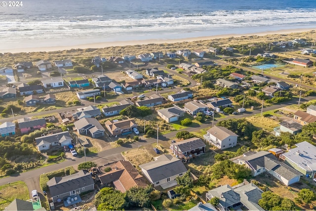 birds eye view of property with a view of the beach and a water view