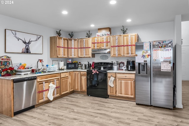 kitchen featuring sink, light hardwood / wood-style flooring, and black appliances