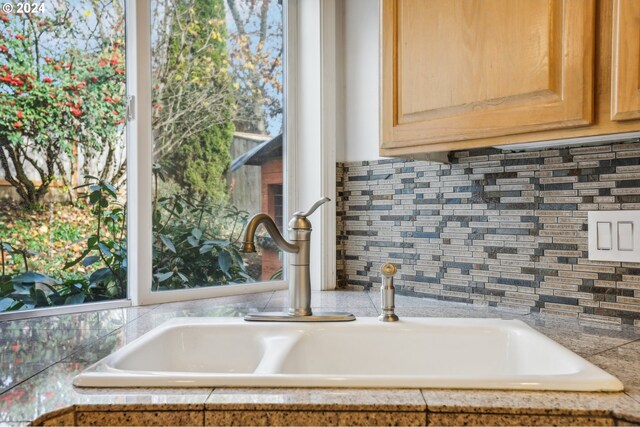 interior details featuring light brown cabinetry and sink