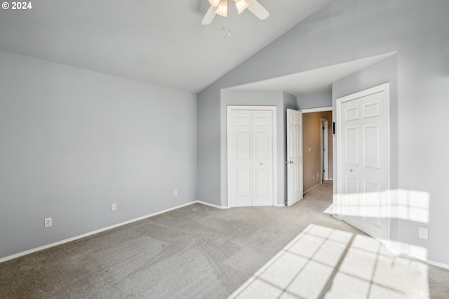 unfurnished bedroom with ceiling fan, light colored carpet, and lofted ceiling