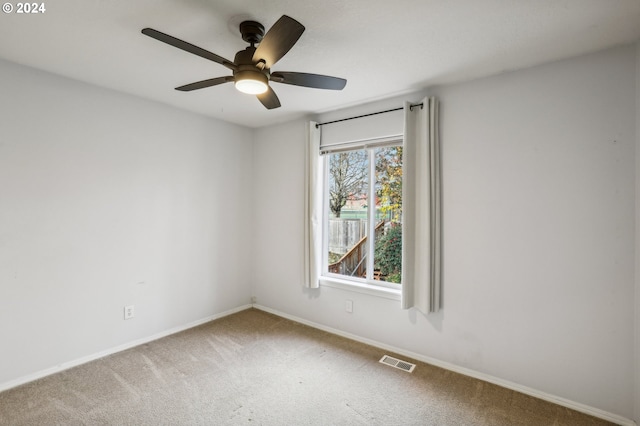 carpeted empty room featuring ceiling fan