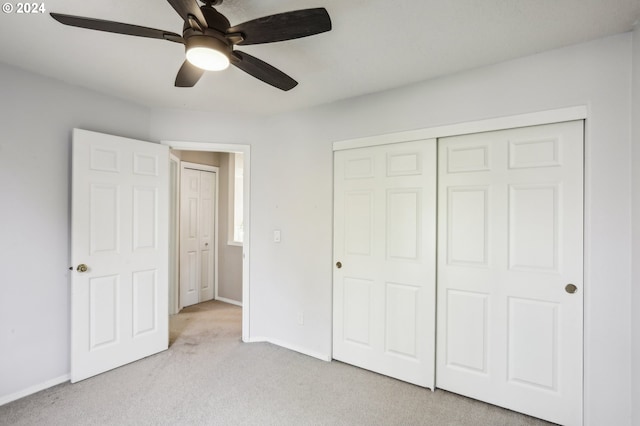 unfurnished bedroom with ceiling fan, light colored carpet, and a closet