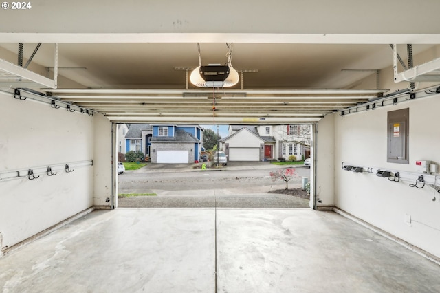 garage featuring electric panel and a garage door opener