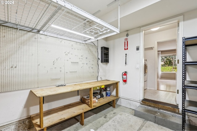 garage featuring a workshop area and washer / dryer