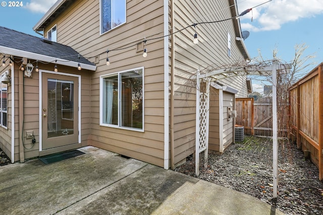 exterior space with central AC unit and a patio