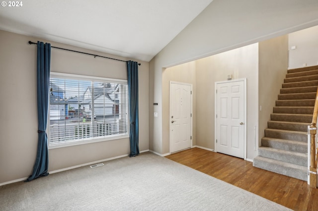 foyer entrance featuring hardwood / wood-style flooring and vaulted ceiling