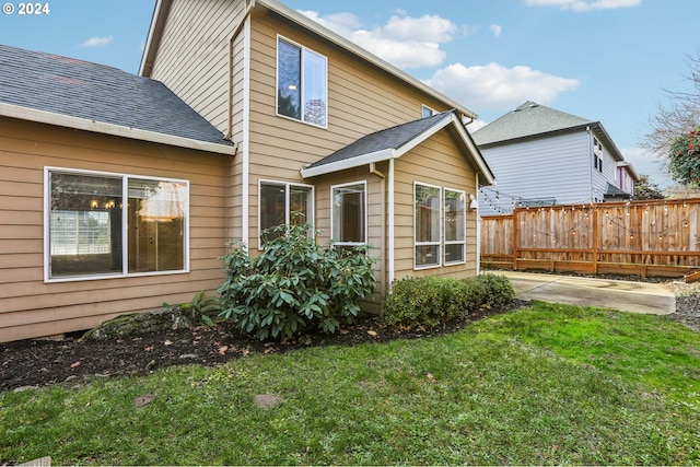 rear view of property featuring a yard and a patio