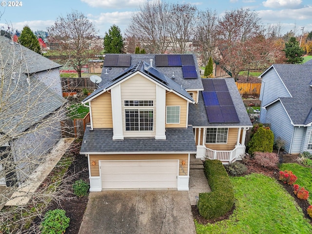 view of front of house featuring solar panels and a garage