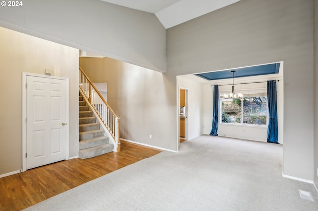 interior space with hardwood / wood-style floors, a chandelier, and lofted ceiling