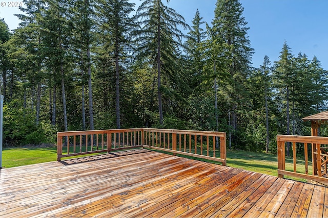 wooden deck featuring a yard