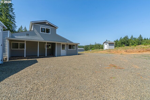 view of front of home featuring a shed