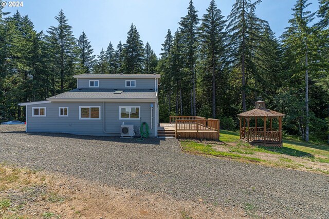 back of house featuring ac unit, a wooden deck, and a gazebo