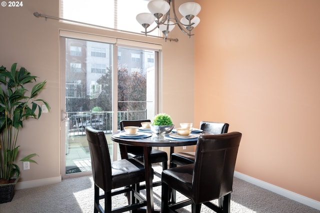 dining area featuring carpet floors and an inviting chandelier