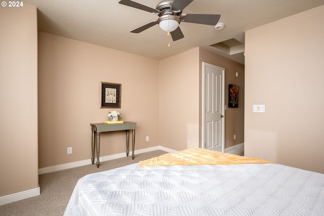 bedroom featuring light carpet, a textured ceiling, and ceiling fan