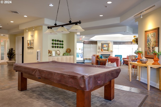 game room with rail lighting and billiards