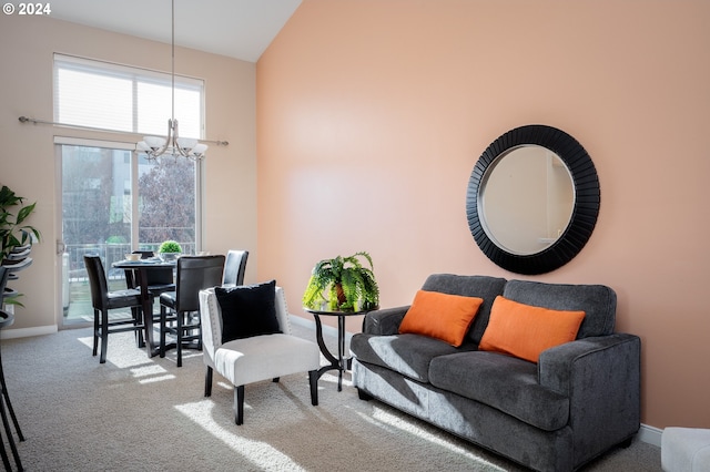 carpeted living room with high vaulted ceiling and a notable chandelier