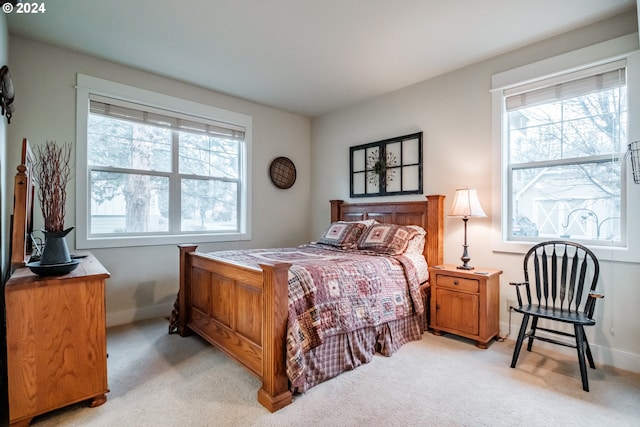 carpeted bedroom with multiple windows