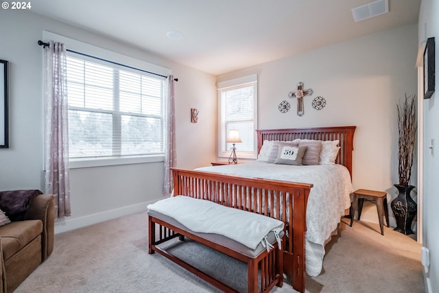 bedroom featuring light carpet