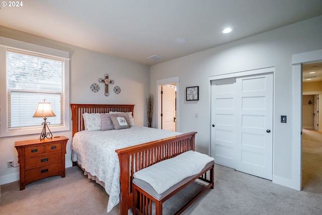 carpeted bedroom with a closet