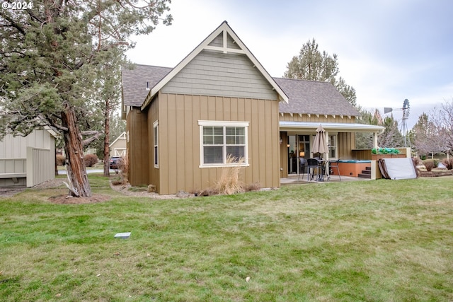 back of property featuring a patio area and a yard