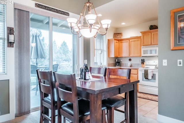 tiled dining space with a chandelier