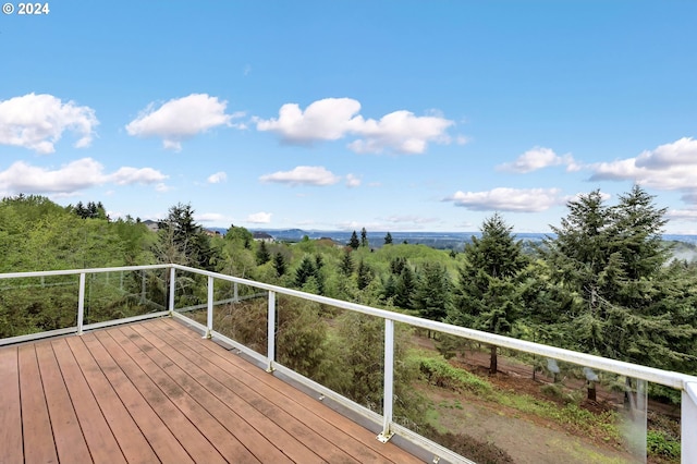 wooden terrace with a view of trees