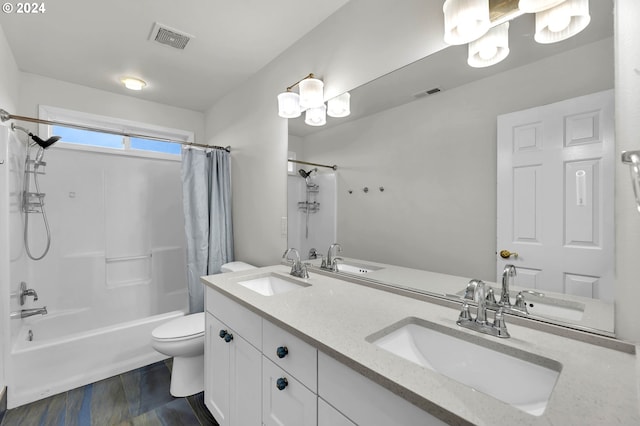 bathroom with visible vents, a sink, and shower / bathtub combination with curtain