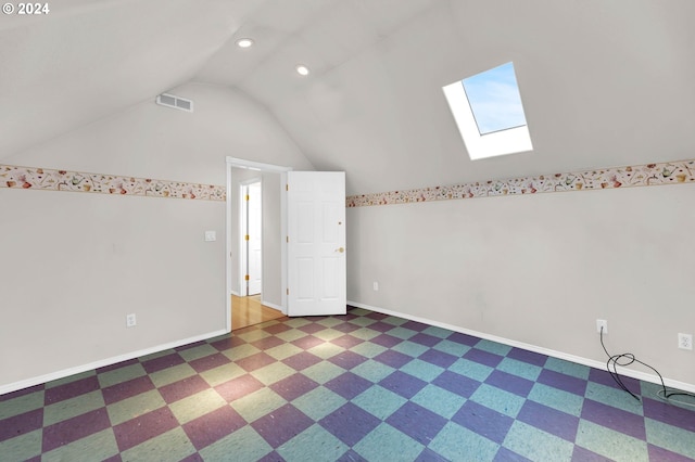 bonus room featuring lofted ceiling with skylight, visible vents, and baseboards