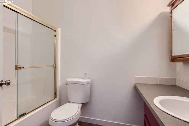 full bathroom featuring enclosed tub / shower combo, vanity, and toilet