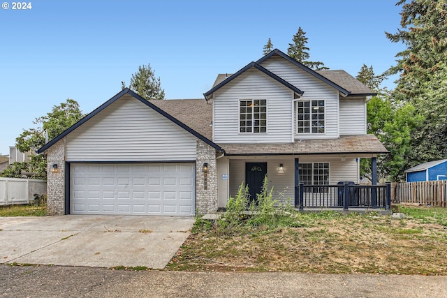 front facade with a porch and a garage