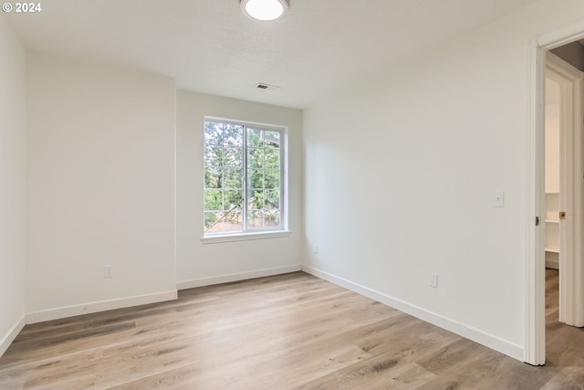 empty room with light hardwood / wood-style flooring