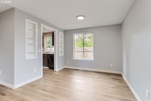 interior space with light wood-type flooring and built in features