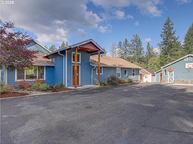 view of front of home featuring a storage shed