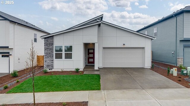 contemporary home featuring a front lawn and a garage