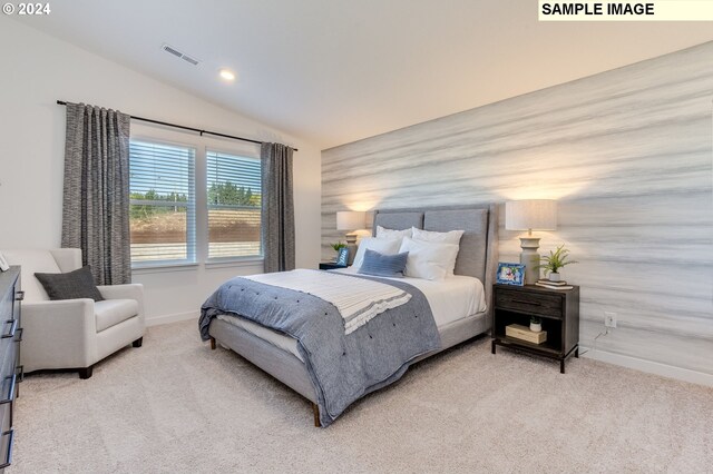 carpeted bedroom featuring lofted ceiling, baseboards, and visible vents