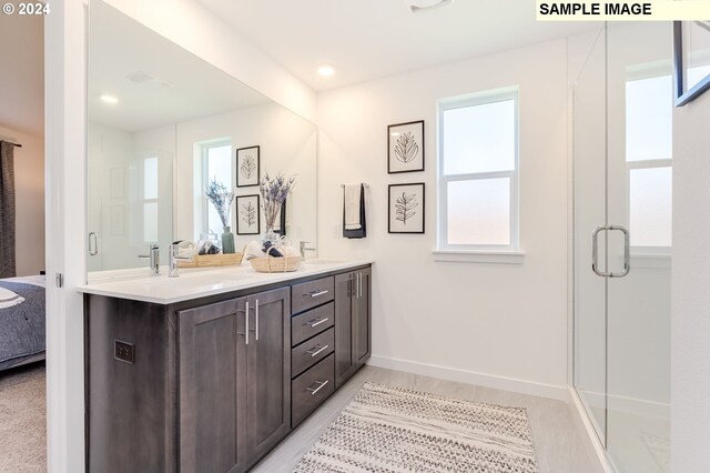 bathroom featuring vanity and a shower with shower door