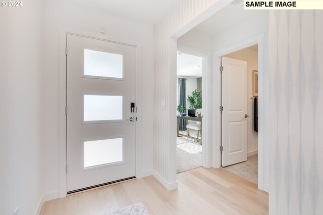 foyer entrance with light hardwood / wood-style flooring