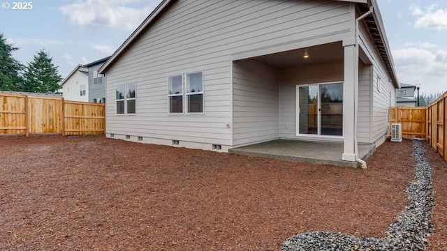 rear view of house featuring a patio, a fenced backyard, and crawl space