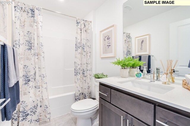 full bathroom featuring tile patterned flooring, vanity, shower / tub combo with curtain, and toilet