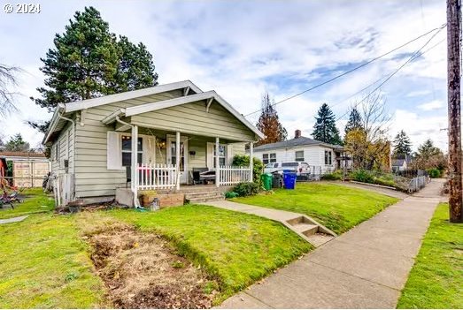 bungalow-style house with a porch and a front yard