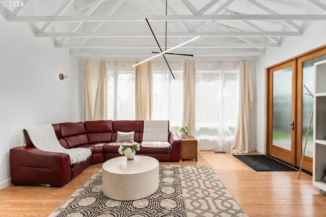 sunroom featuring french doors and lofted ceiling with beams