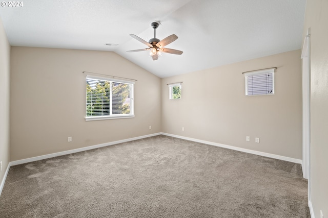 carpeted empty room with ceiling fan and lofted ceiling