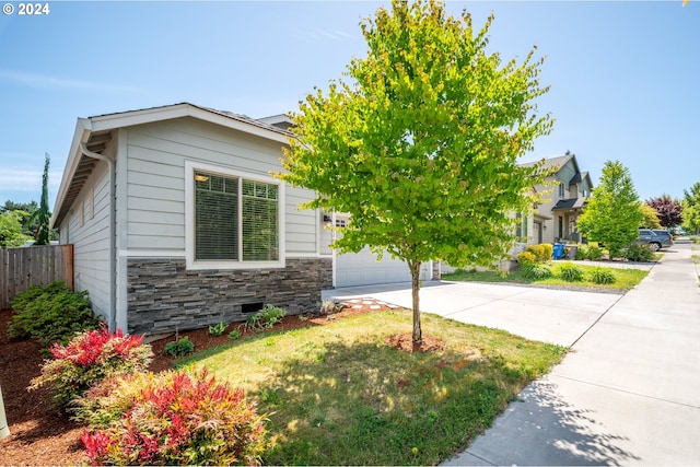 view of front of house with a garage and a front lawn