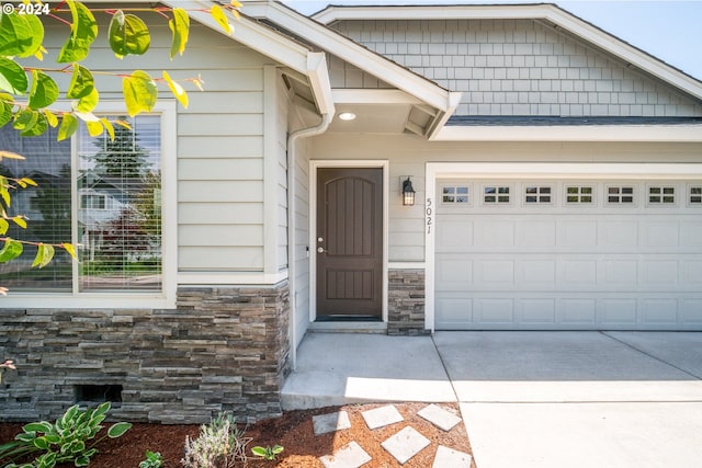 view of exterior entry featuring a garage