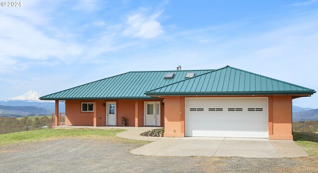 view of front of property with a mountain view and a garage