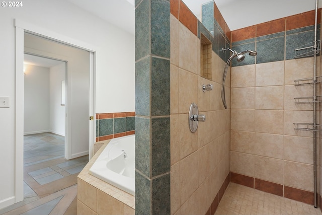 bathroom featuring a garden tub and tiled shower