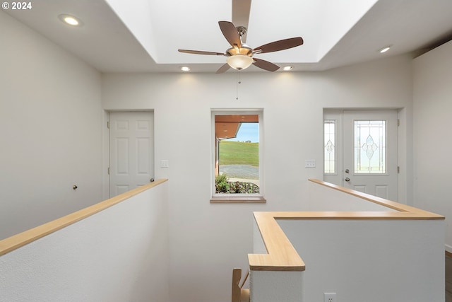 hallway with a wealth of natural light, recessed lighting, and an upstairs landing