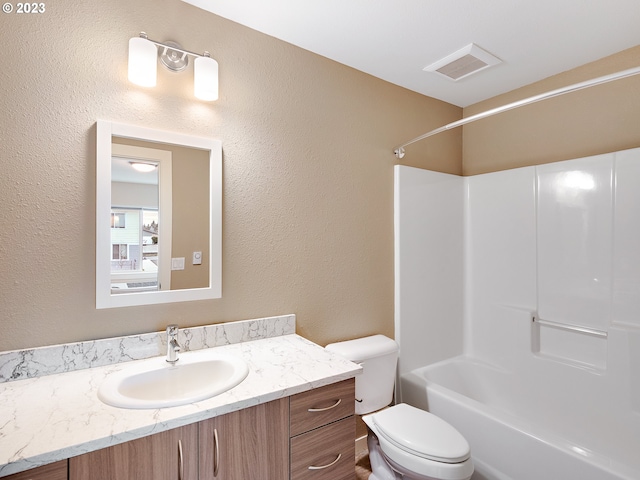 full bathroom featuring washtub / shower combination, vanity, and toilet