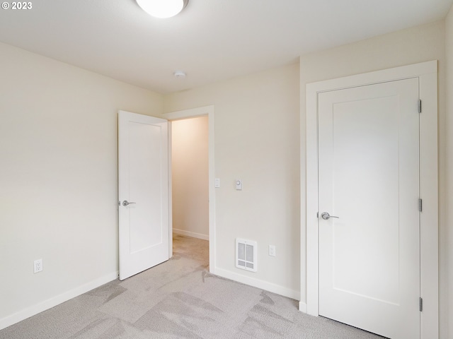 unfurnished bedroom featuring light carpet