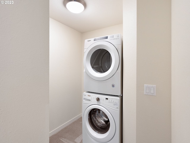 clothes washing area with carpet and stacked washing maching and dryer